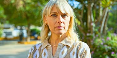 financially comfortable woman dressed up standing outside