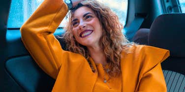 happy woman enjoying her life laughing in her car