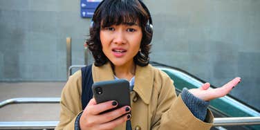 irritated young woman annoyed by incompetence on her phone