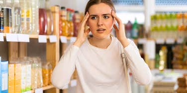 young woman feeling annoyed while running errands