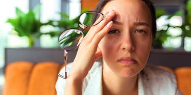 unhappy woman at work looking stressed