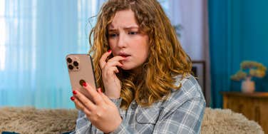 stressed woman looking at home unable to deal with bad news