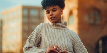 confident woman with a strong backbone standing tall outside