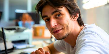 man with an elite mind smiling thinking deeply