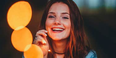 happy woman with a zest for life smiling in the light