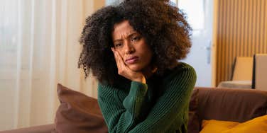 deeply stressed woman trying to pretend she's okay