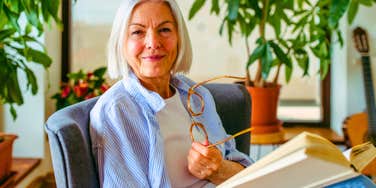 older woman reading a book to feel safe