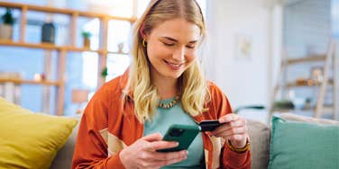 naive young woman holding credit card to borrow money