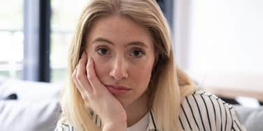 Woman zones out during conversation.