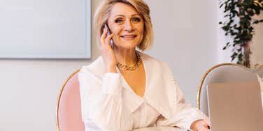 older professional boomer woman on the phone in an office