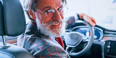 boomer man driving across town to buy something