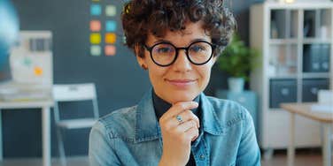 confident millennial woman boss at work