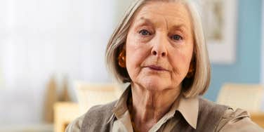 miserable older woman looking unhappy at home