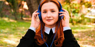 empathic woman listening to music and smiling