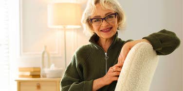 older woman smiling in her living room chair