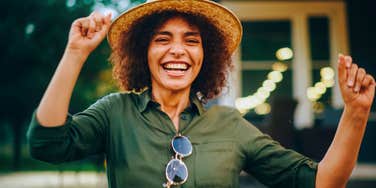 happy woman having fun dancing outside