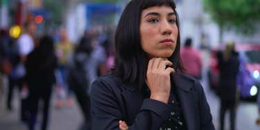 socially anxious woman looking worried in public