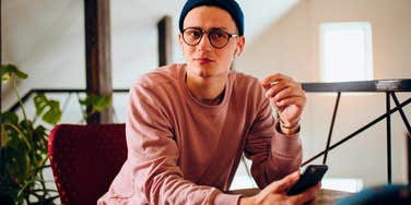 young man on his phone refusing to pay for things older people will