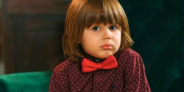 fancy child sitting all alone feeling insecure