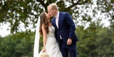 A bride and groom kissing on the wedding day 