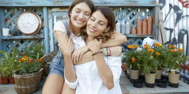 mother and daughter embracing and posing for photo together