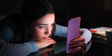 confused girl on phone at night