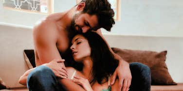 man cuddling woman