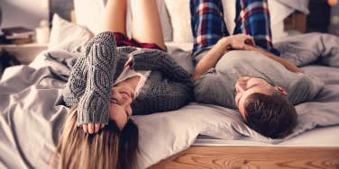couple lying on the bed, talking to each other