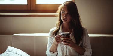 girl sitting alone drinking coffee