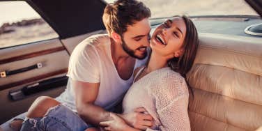 couple laughing in car