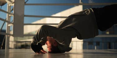 man holding himself up by his hands