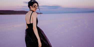 woman standing by ocean 