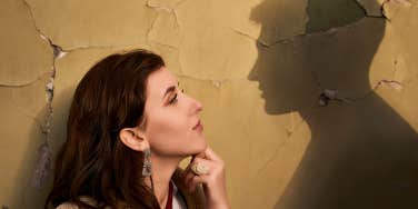 Woman looking at mans shadow 