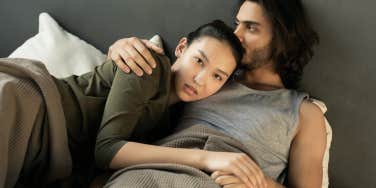 a couple lying in bed together