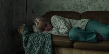 depressed woman laying on couch