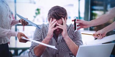 stressed man overwhelmed with work