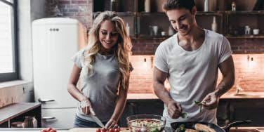 man cooking with woman