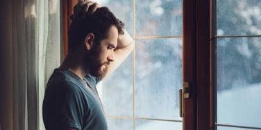 sad man looking out window