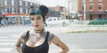 woman in low-cut tanktop and blue hair