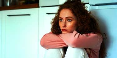 woman sitting in kitchen alone