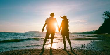 couple holding hands on the beach