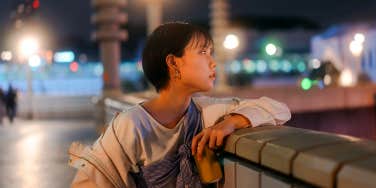 single woman overlooking city