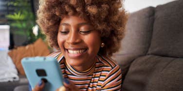 smiling girl looking at phone