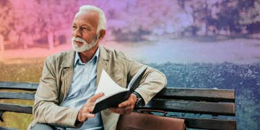 older man sitting on a bench reading a book