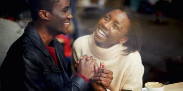 Laughing young couple in cafe