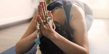 woman with hands in prayers