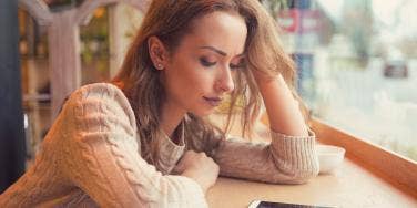 sad woman looking at her phone