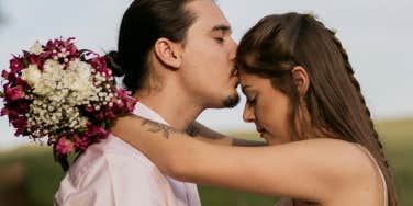 couple man kissing woman's head