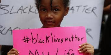 Black child holding a Black Lives Matter sign