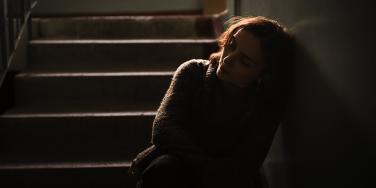 sad woman sitting in the dark